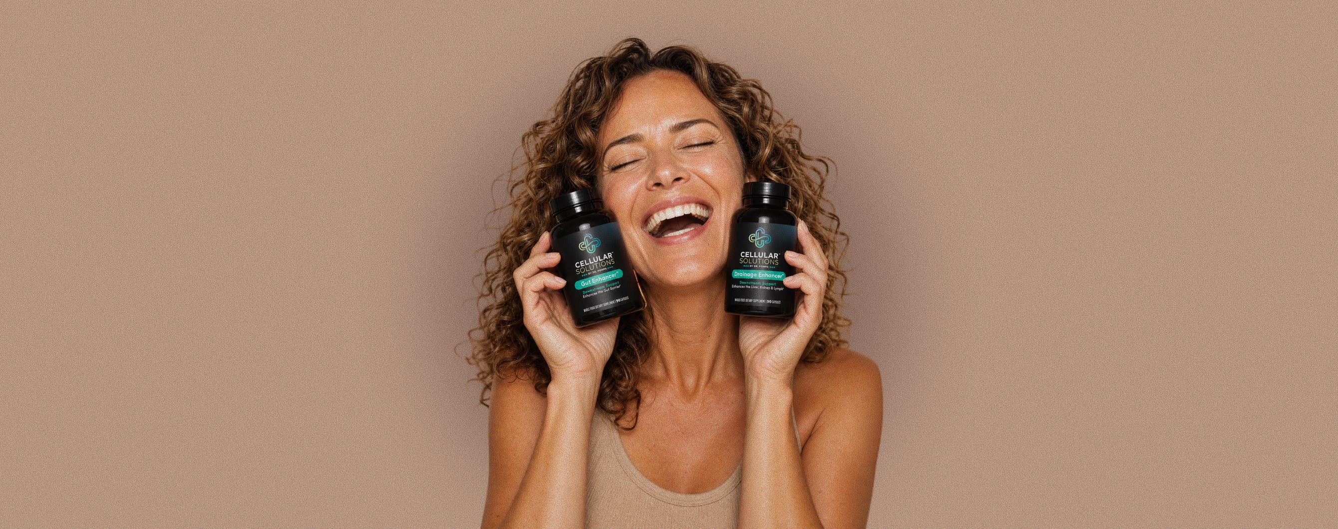 Woman holding Cellular Solutions supplements for detox, drainage, and cellular wellness support.