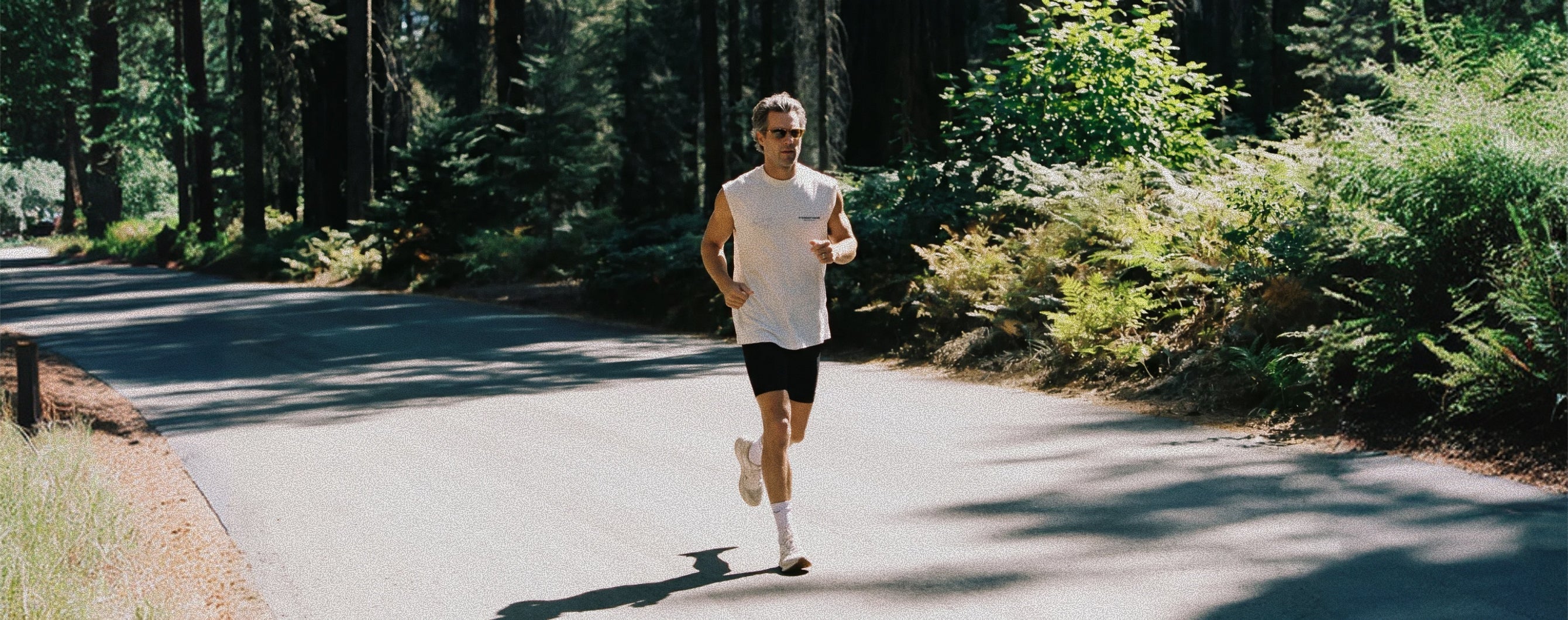 Man jogging on a forest road to support joint mobility, active recovery, and healthy movement 